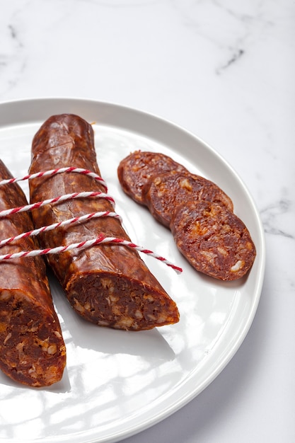 Assortment of typical Spanish homemade sausages with a colorful background. Iberian Chorizo and Salchichon