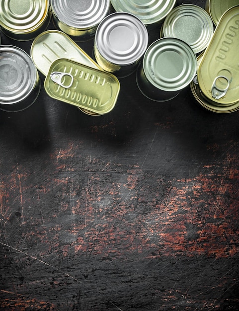 Assortment of various closed tin cans with canned food