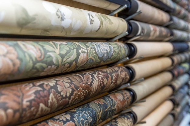 Assortment of wallpaper in rolls in the store Interior design and decor construction and repair Side view Selective focus