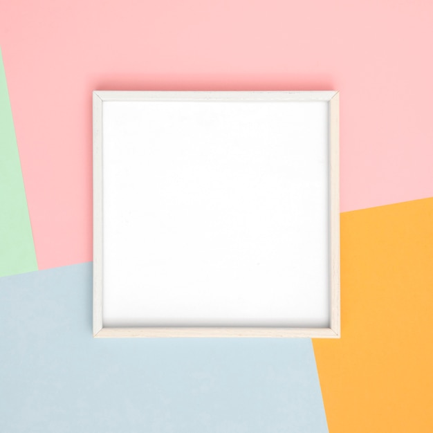 Assortment with empty white frame on wall