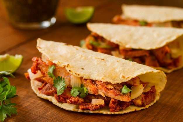 Assortment with tacos on wooden background