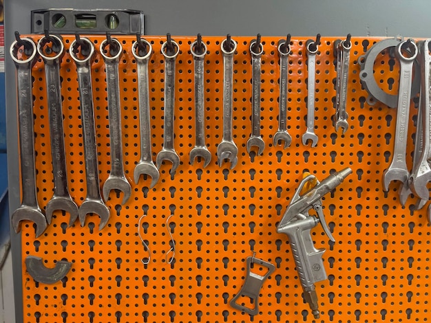 Photo assortment of wrenches hanging on wall