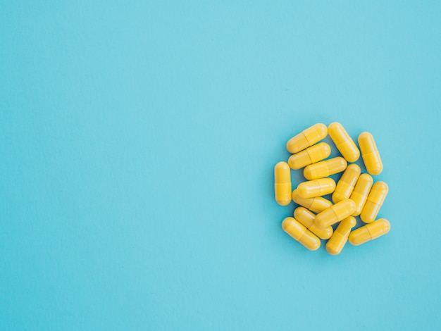 Assortment of yellow medicinal pharmaceutical capsules. Concept of healthcare and medicine. treatment of viruses