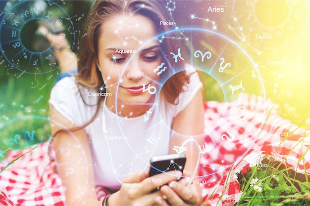 Astrology smartphone app concept, woman using mobile phone, close up of hands            - Image