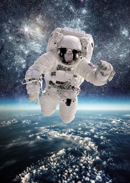 Astronaut in outer space against the backdrop of the planet earth. Elements of this image furnished by NASA.