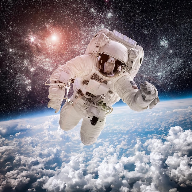 Astronaut in outer space against the backdrop of the planet earth. Elements of this image furnished by NASA.