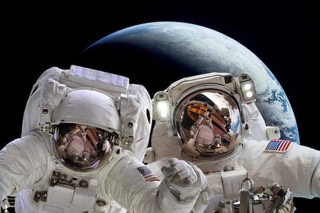 Astronaut in outer space against the backdrop of the planet earth. Elements of this image furnished by NASA.