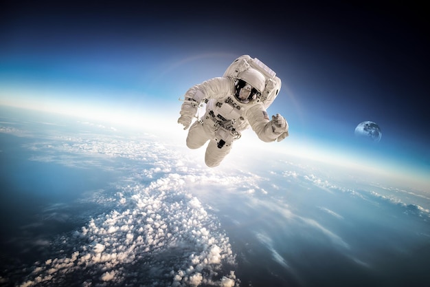 Astronaut in outer space against the backdrop of the planet earth. Elements of this image furnished by NASA.