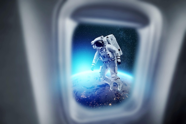 An astronaut in a white spacesuit hanging in space against the backdrop of planet earth Copy space