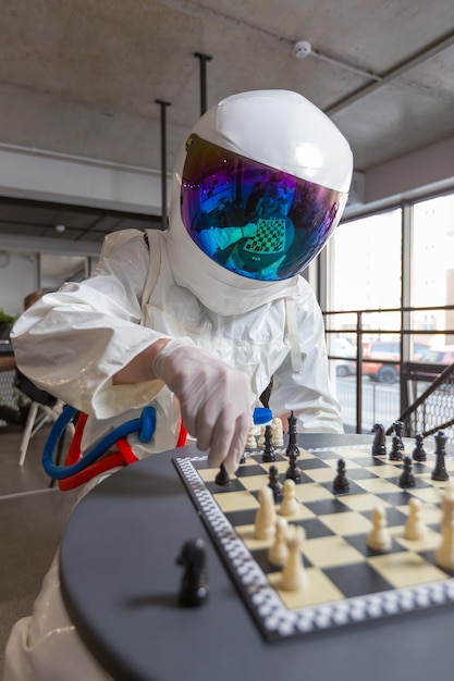 Astronauts playing chess in space suits in capsule hotel