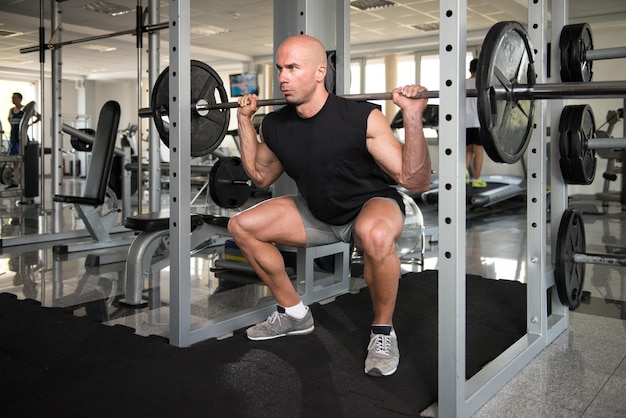 Athlete Doing Exercise For Legs With Barbell