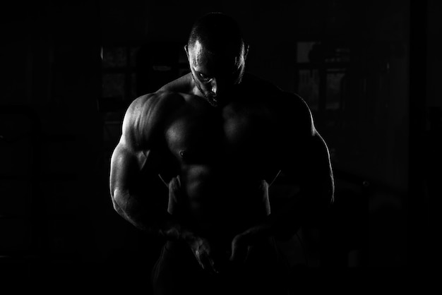 Athlete Muscular Bodybuilder Posing In The Gym