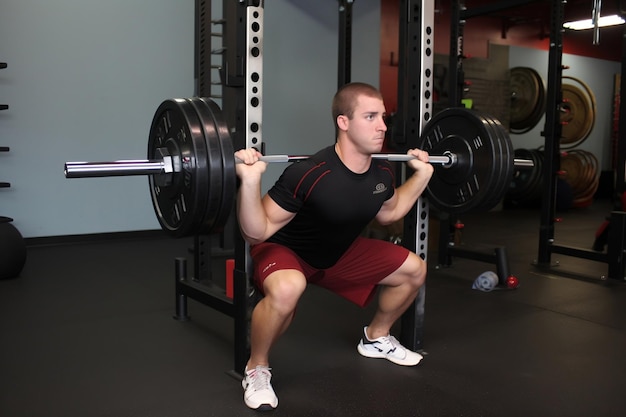 The athlete squats with a barbell AI Generated