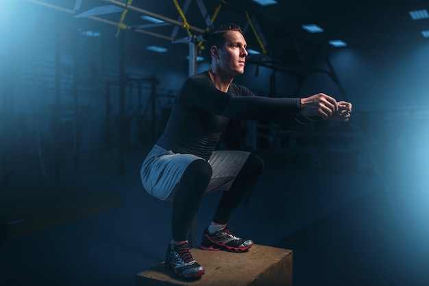 Athlete on training, endurance exercise with box