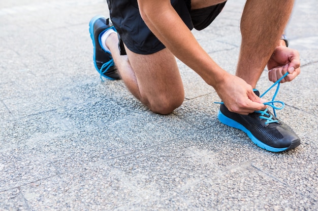 Athlete tying his shoes