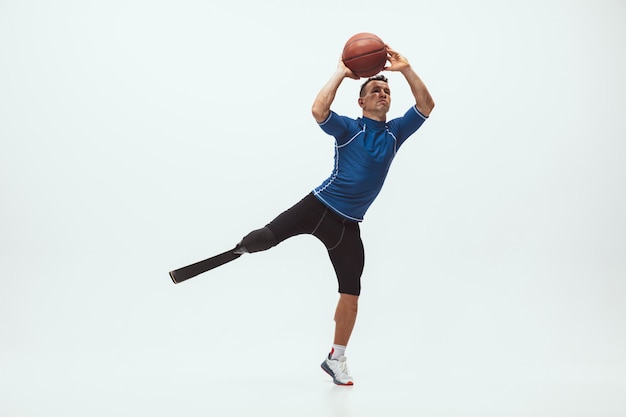 Athlete with disabilities or amputee on white studio background, basketball