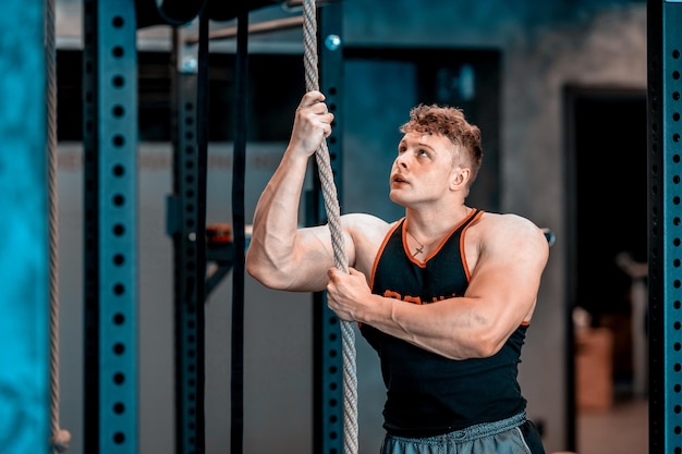 Athlete with rope in gym