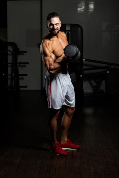 Athlete Working Out Biceps In A Gym  Dumbbell Concentration Curls