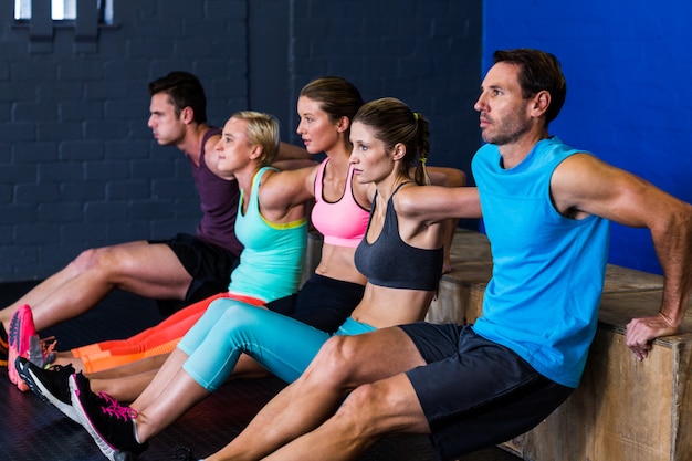 Athletes exercising on wooden box