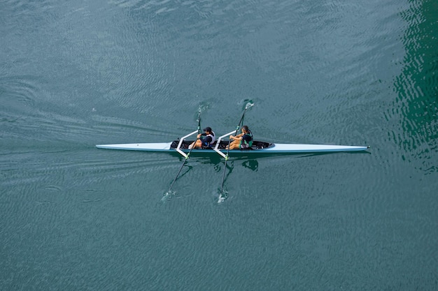 athletes training in canoe in the Nervion river in Bilbao city, basque country, spain