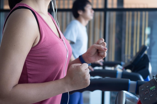 Athletes work out in the fitness room Healthy people run on a treadmill in the fitness room to exercise