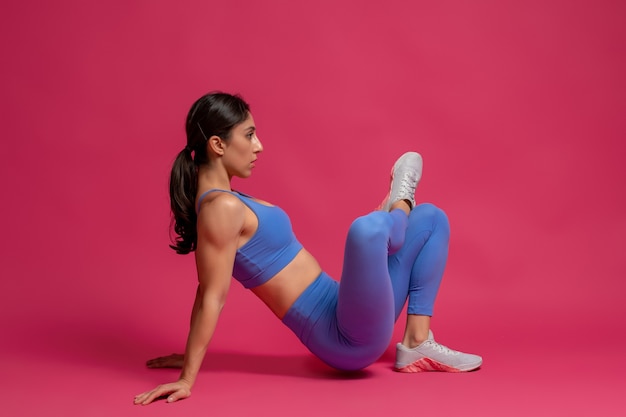 Athletic brunette performing stretching workout