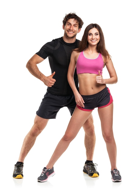 Athletic couple man and woman with thumb up on the white background