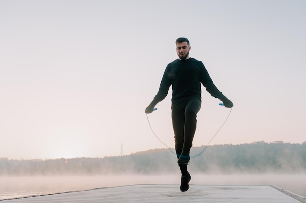 Athletic male jumping the rope outside