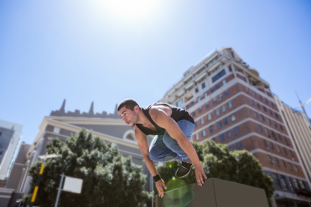 Athletic man doing parkour in the city