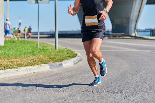 Athletic man jogging in sportswear in the city