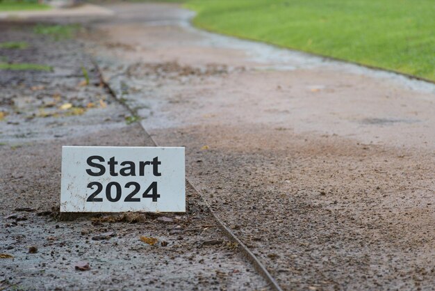 Athletic poster announcing the beginning of the year 2024 on a muddy road