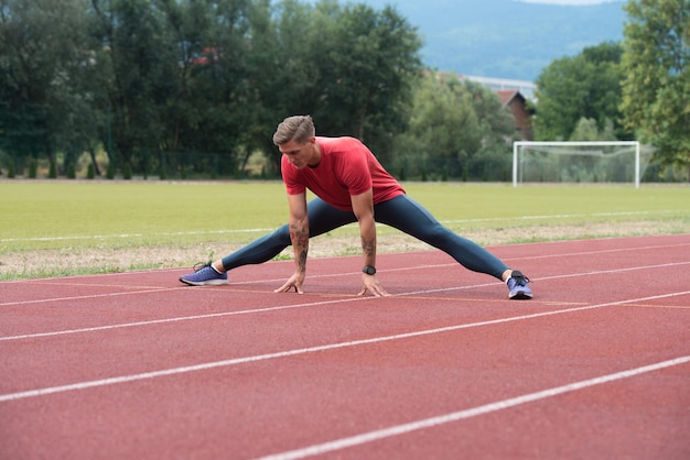 Athletic Runner Doing Stretching Exercise