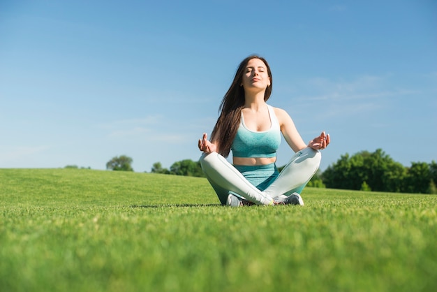 Athletic woman practicing yoga outdoor