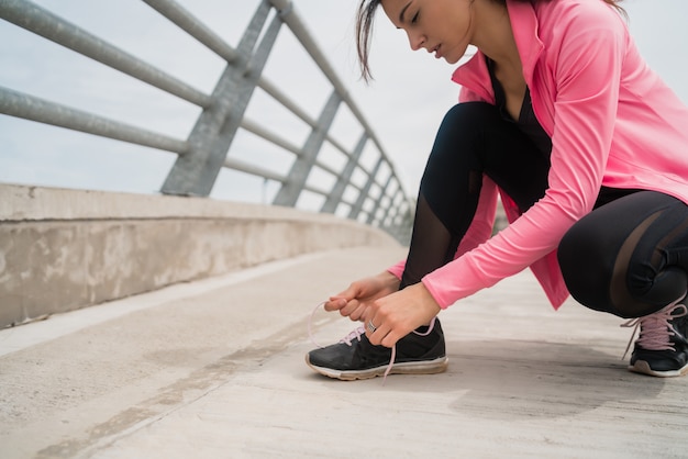 Athletic woman  tying her shoelaces.