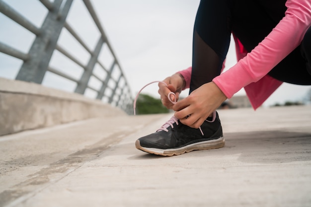 Athletic woman  tying her shoelaces.