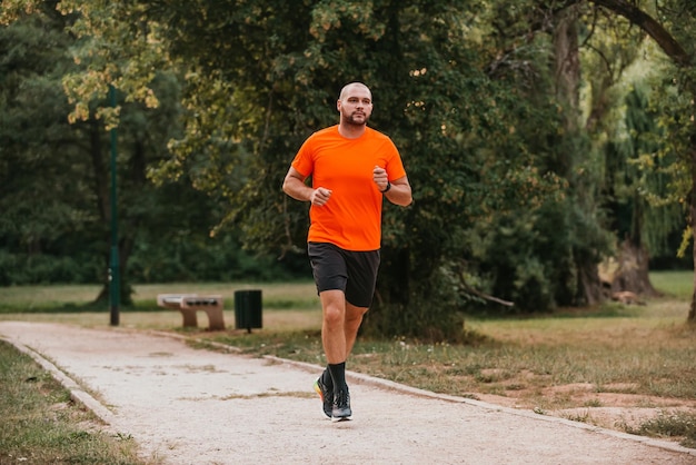 Athletic young man running in nature Healthy lifestyle