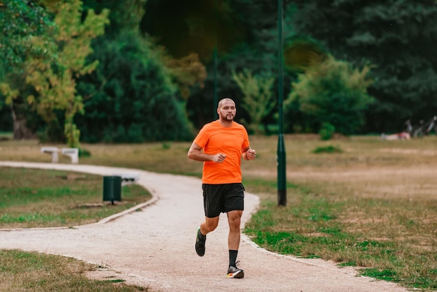 Athletic young man running in nature Healthy lifestyle