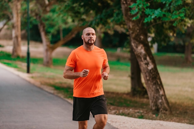 Athletic young man running in nature Healthy lifestyle