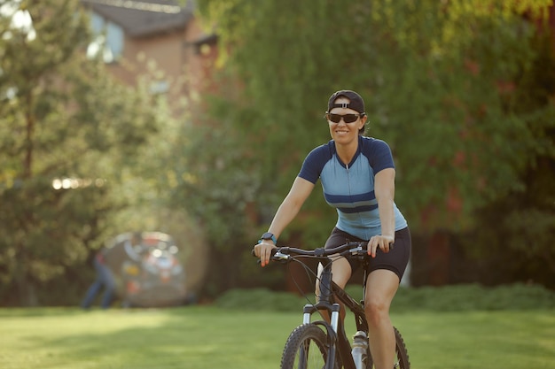 Athletic young woman cycling in the park