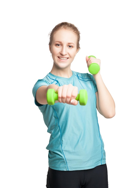 Athletic young woman works out with green dumbbells isolated on white