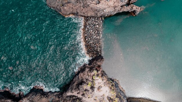 Atlantic ocean coastline with rocks turquoise waves Madeira island Portugal aerial drone photo