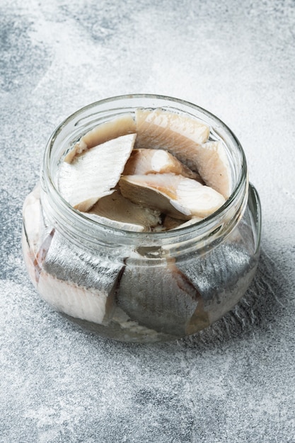 Atlantic wild herring, Pickled Canned  fish preserves set, in glass jar, on gray