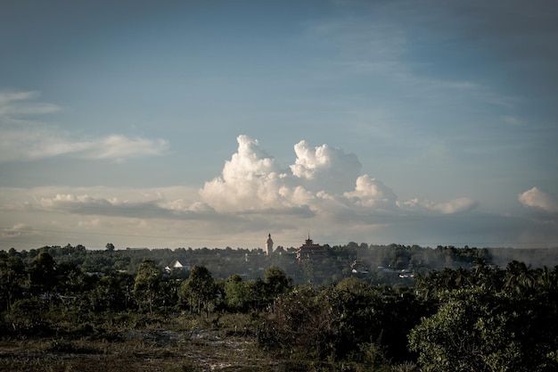 Atmosphere panorama cumulus white clouds over buddhist temple statue Dramatic Sky Sunset Meditation background