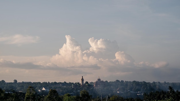 Atmosphere panorama cumulus white clouds over buddhist temple statue Dramatic Sky Sunset Meditation background