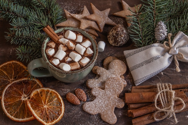 Atmospheric Christmas or New Year composition with a cup of cocoa with marshmallows gingerbread