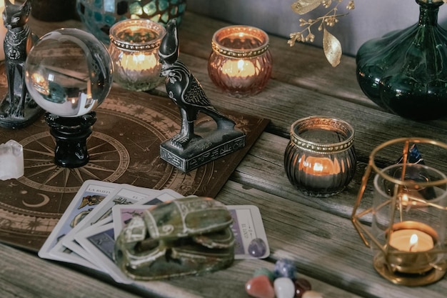 Photo an atmospheric setting featuring a crystal ball egyptian cat statues candles and crystals creating a mystical ambiance