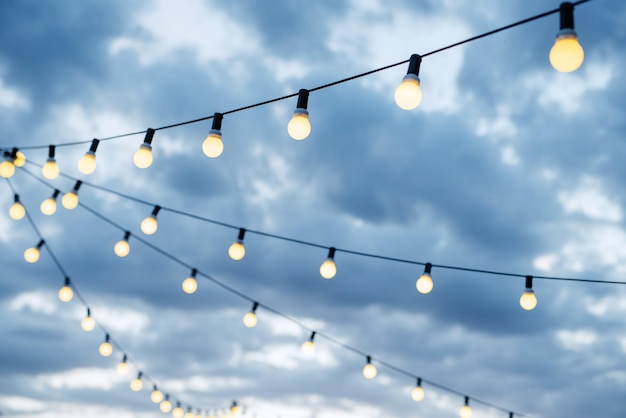 Atmospheric warm light bulbs wrapped in garlands to decorate the holiday