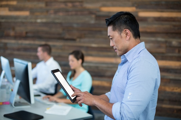 Attentive businessman using digital tablet