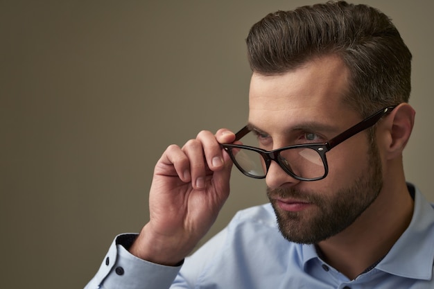 Attentive glance of the man with poor eyesight