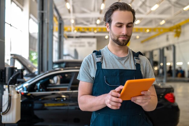 Attentive man looking at tablet screen